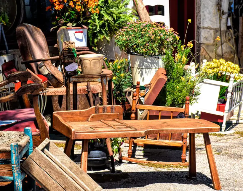 A wooden table and chairs outside in the sun.
