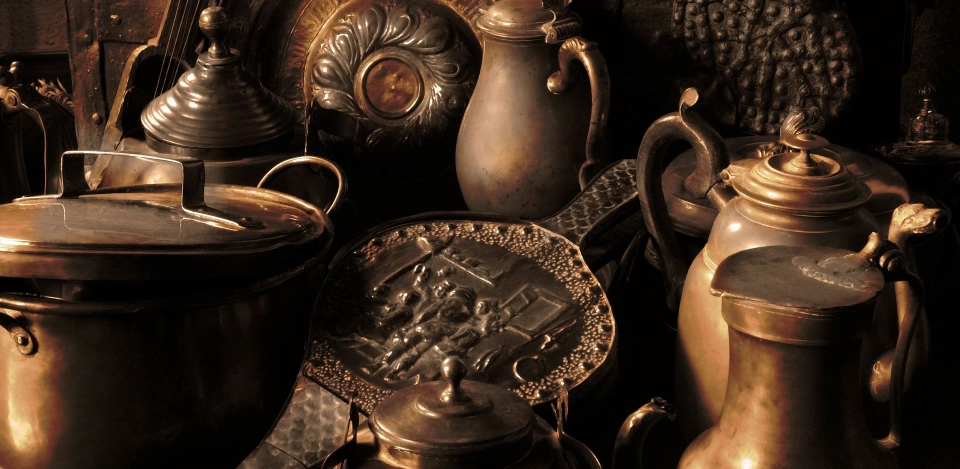 A close up of some antique tea pots