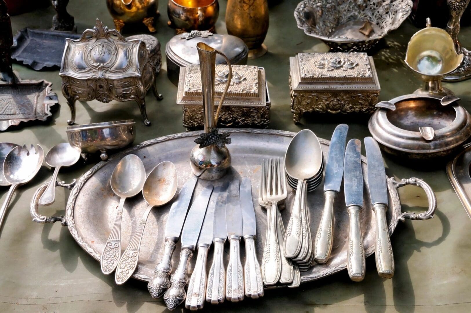 A table with silverware and other items on it.